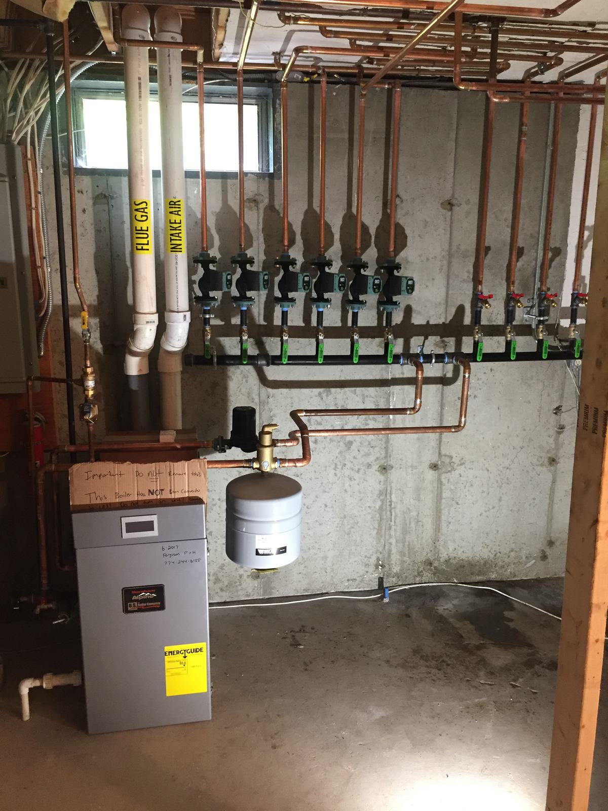 Six-zone copper Taco manifold installed on a condensing boiler by Ferguson Plumbing Design