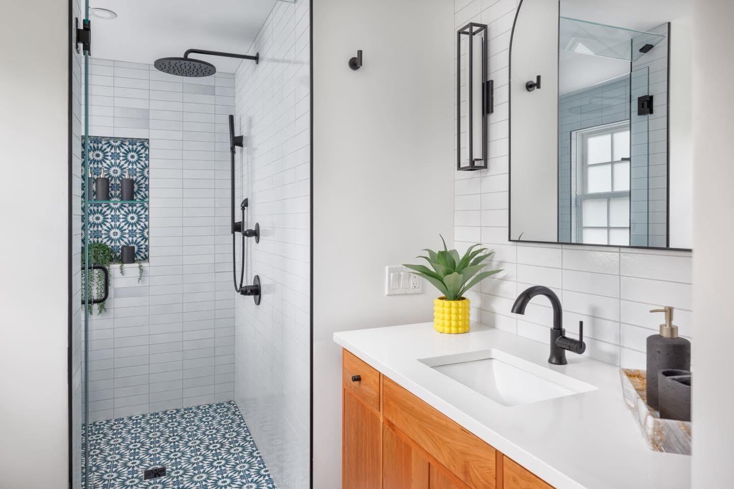 Finished bathroom remodel with patterned tile feature wall, plumbing by Ferguson Plumbing Design